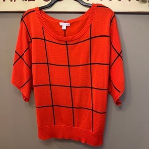 Red and black knit sweater like top. Very cute and versatile